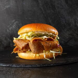 Halal doner meat in brioche bun with shredded lettuce at Bross Slice and Grill
