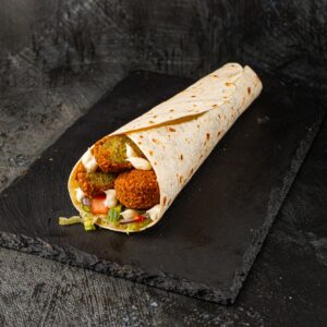 Vegetarian falafel wrap with tahini sauce and fresh salad at Bross Slice and Grill