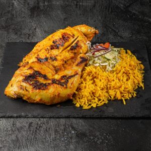 Half peri peri chicken with yellow rice and side salad at Bross Slice and Grill
