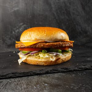Halal lamb burger with cheddar, tomato and lettuce in brioche bun at Bross Slice and Grill