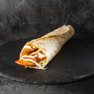 Grilled peri peri chicken wrap with lettuce and cream sauce at Bross Slice and Grill